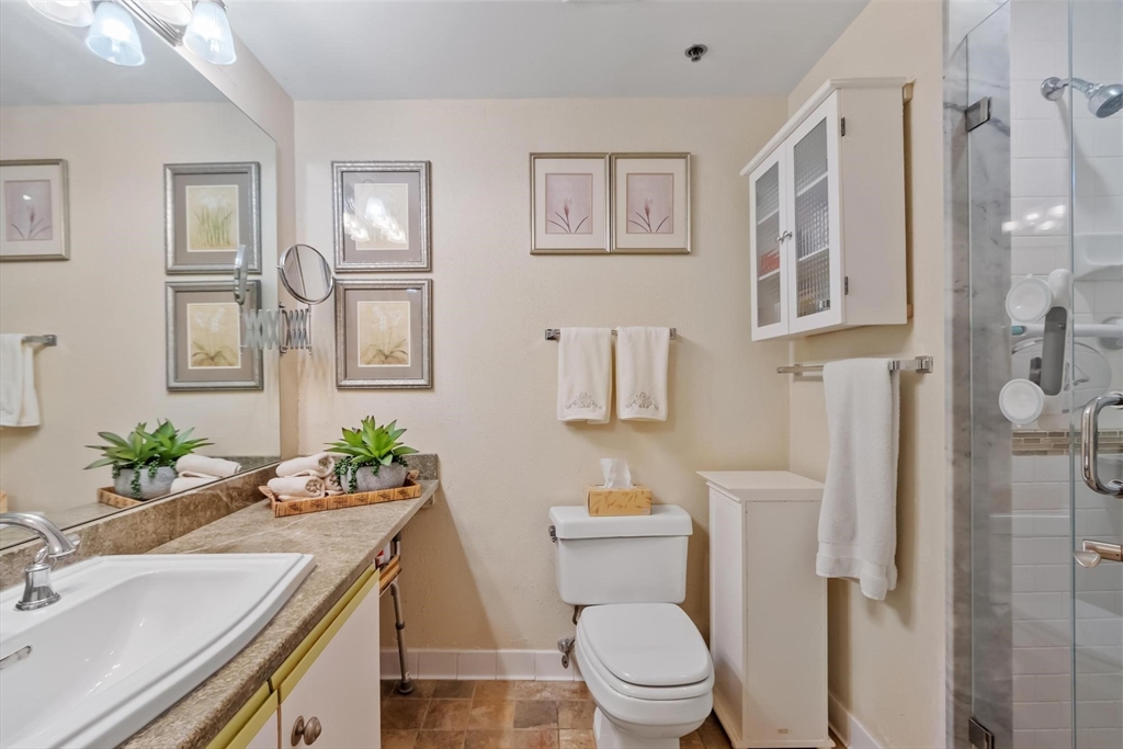 22 Railroad Street, Unit 504 Andover, MA 01810 - Photo 18 of 28 a bathroom with a granite countertop toilet sink and mirror