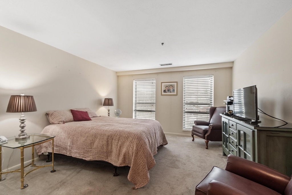22 Railroad Street, Unit 504 Andover, MA 01810 - Photo 20 of 28 a bedroom with a bed and wooden floor