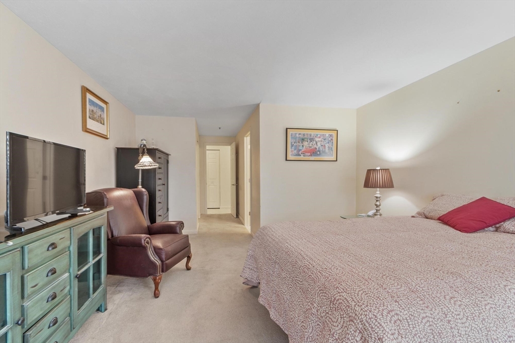 22 Railroad Street, Unit 504 Andover, MA 01810 - Photo 21 of 28 a bedroom with a bed and a flat screen tv