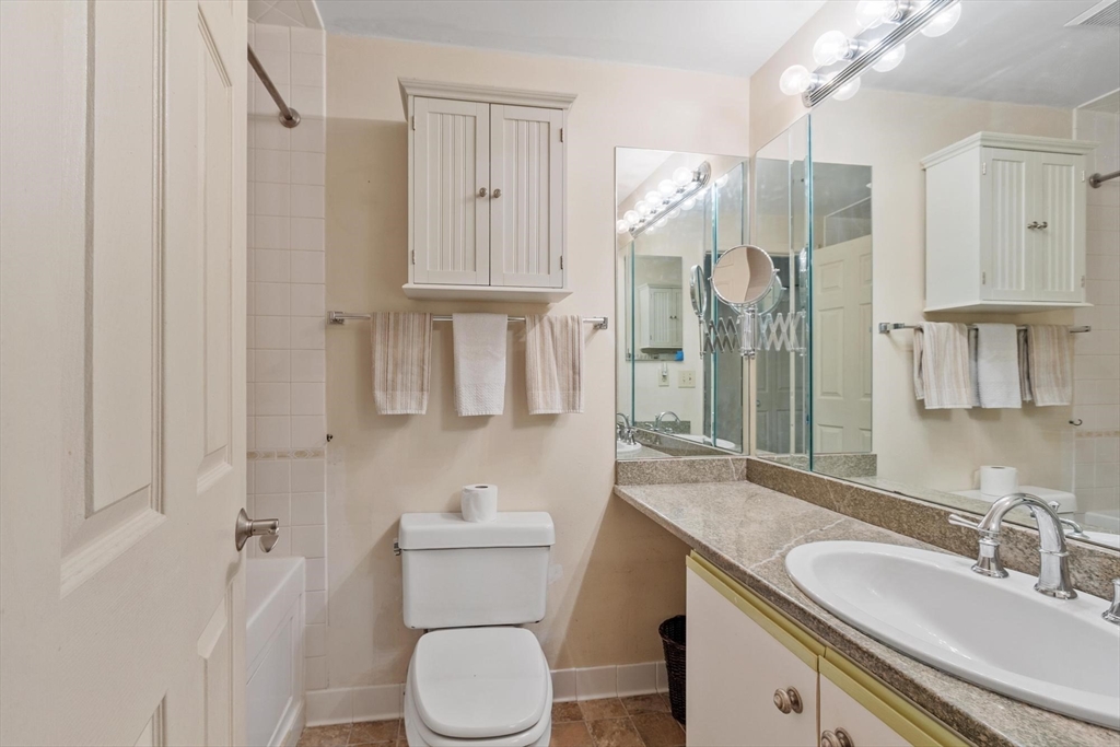 22 Railroad Street, Unit 504 Andover, MA 01810 - Photo 22 of 28 a bathroom with a granite countertop sink toilet and shower