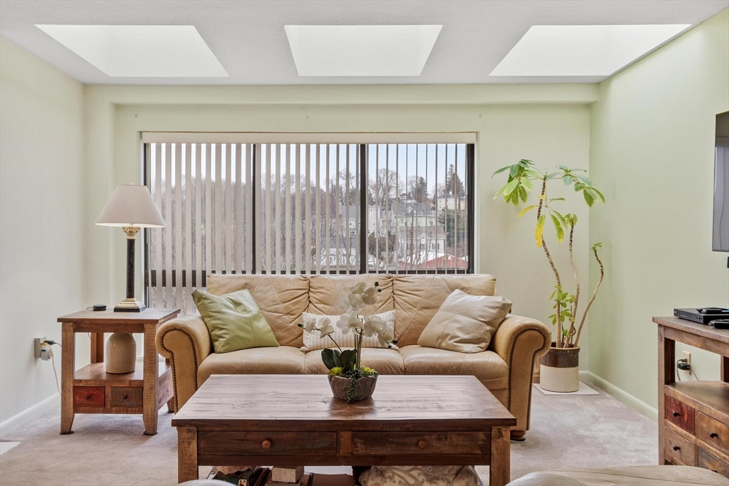 22 Railroad Street, Unit 504 Andover, MA 01810 - Photo 6 of 28 a living room with furniture and a window