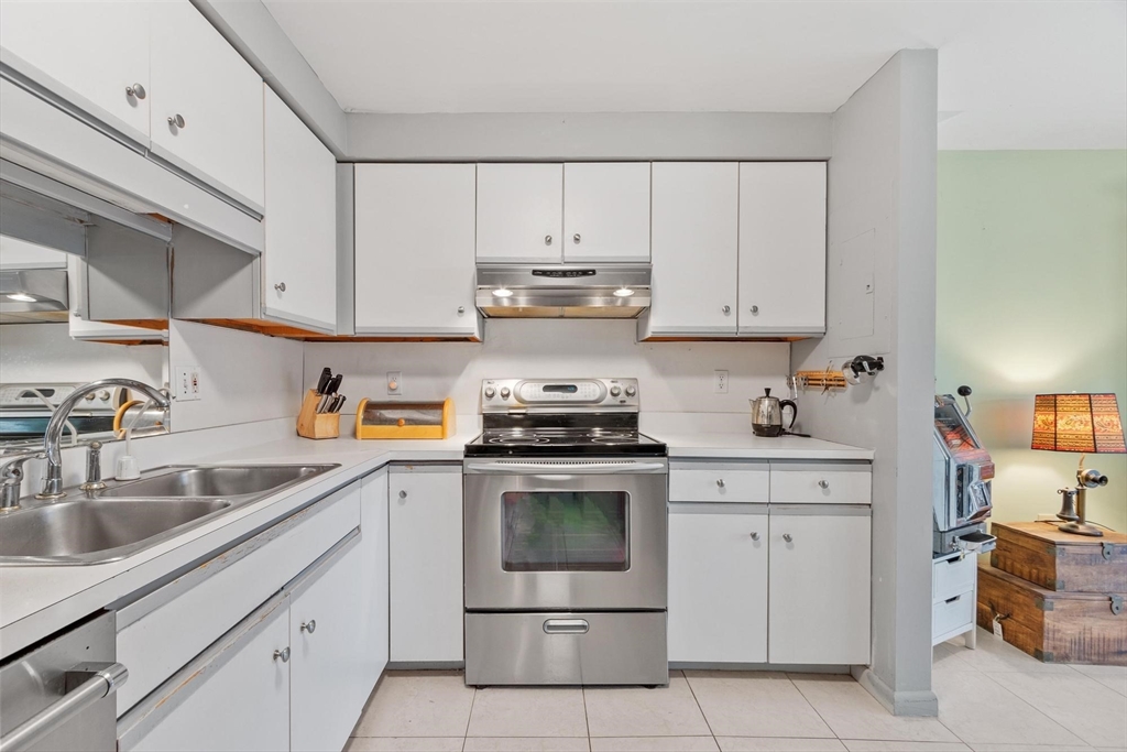 22 Railroad Street, Unit 504 Andover, MA 01810 - Photo 10 of 28 a kitchen with cabinets appliances and a sink