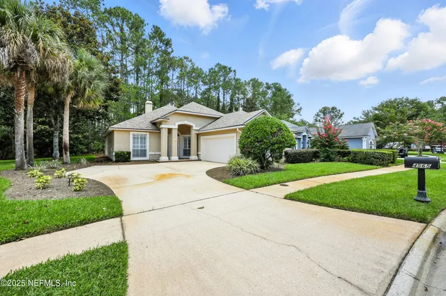 a front view of house with yard and green space