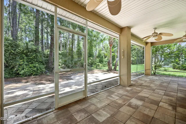 an aerial view of residential houses with outdoor space and trees