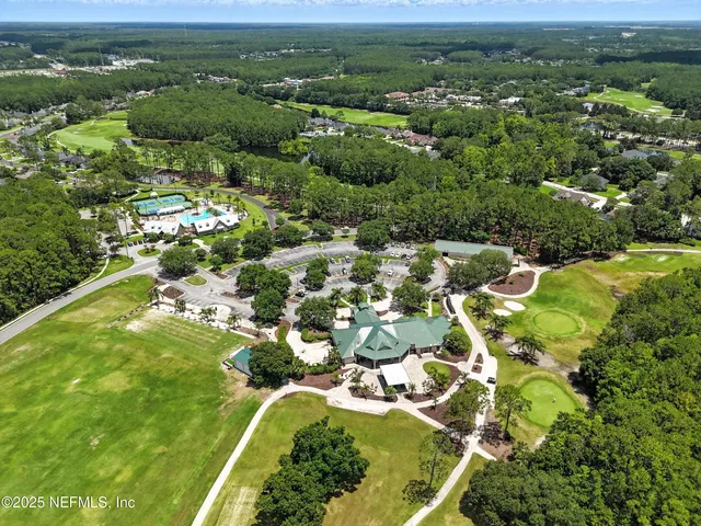 a view of an empty room with chandelier and a window