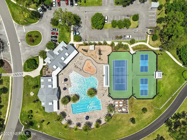 an aerial view of a residential houses with outdoor space and street view