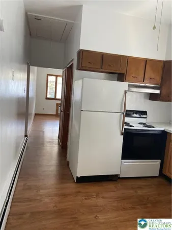 a view of kitchen with furniture and wooden floor