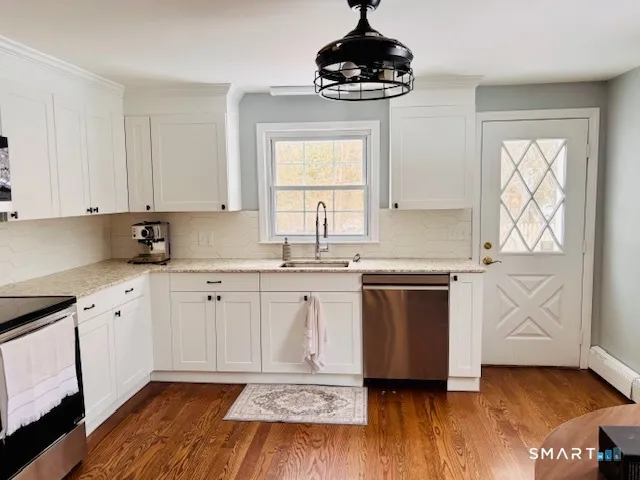 a kitchen with a sink cabinets and window