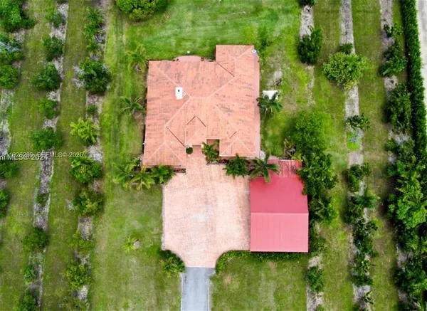 an aerial view of residential house with outdoor space and swimming pool