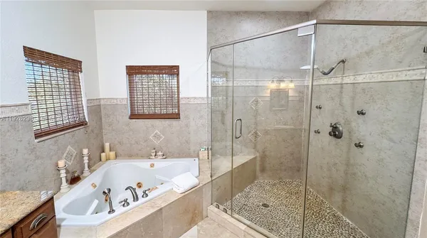 a bathroom with a granite countertop sink mirror and vanity