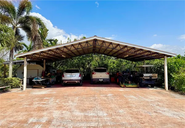a view of patio with a table and chairs under an umbrella
