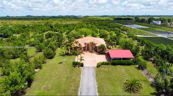 a view of a lake with a house in a yard