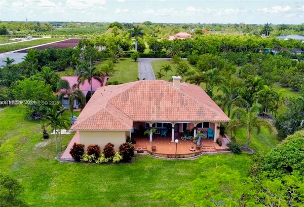 a view of a house with garden and a patio