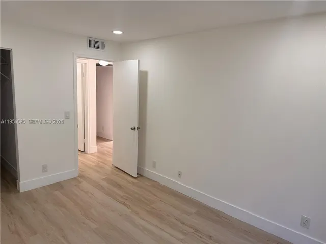 a view of hallway with wooden floor