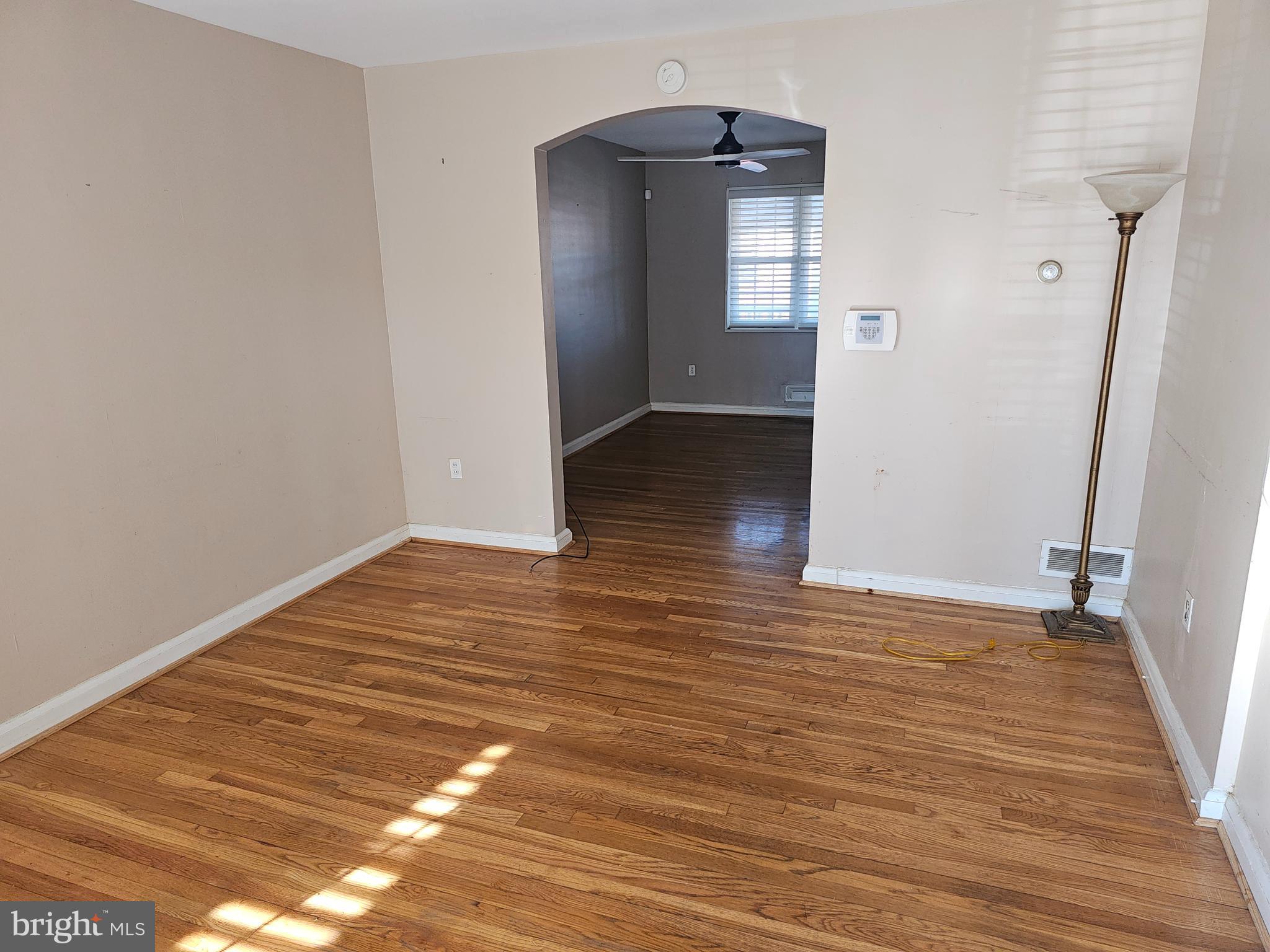 4728 Williston Street Baltimore, MD 21229 - Photo 2 of 17 a view of empty room with wooden floor and fan