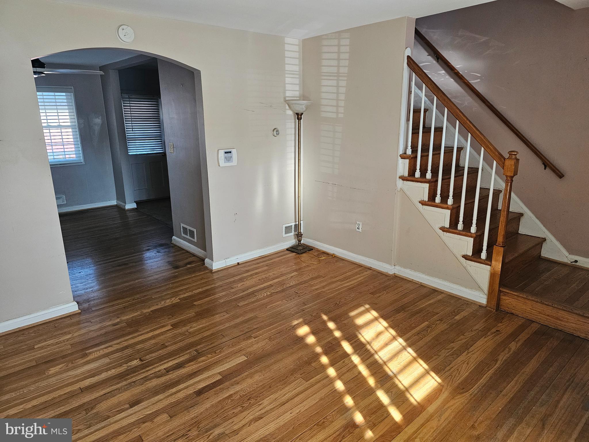4728 Williston Street Baltimore, MD 21229 - Photo 3 of 17 a view of a hallway with wooden floor and staircase