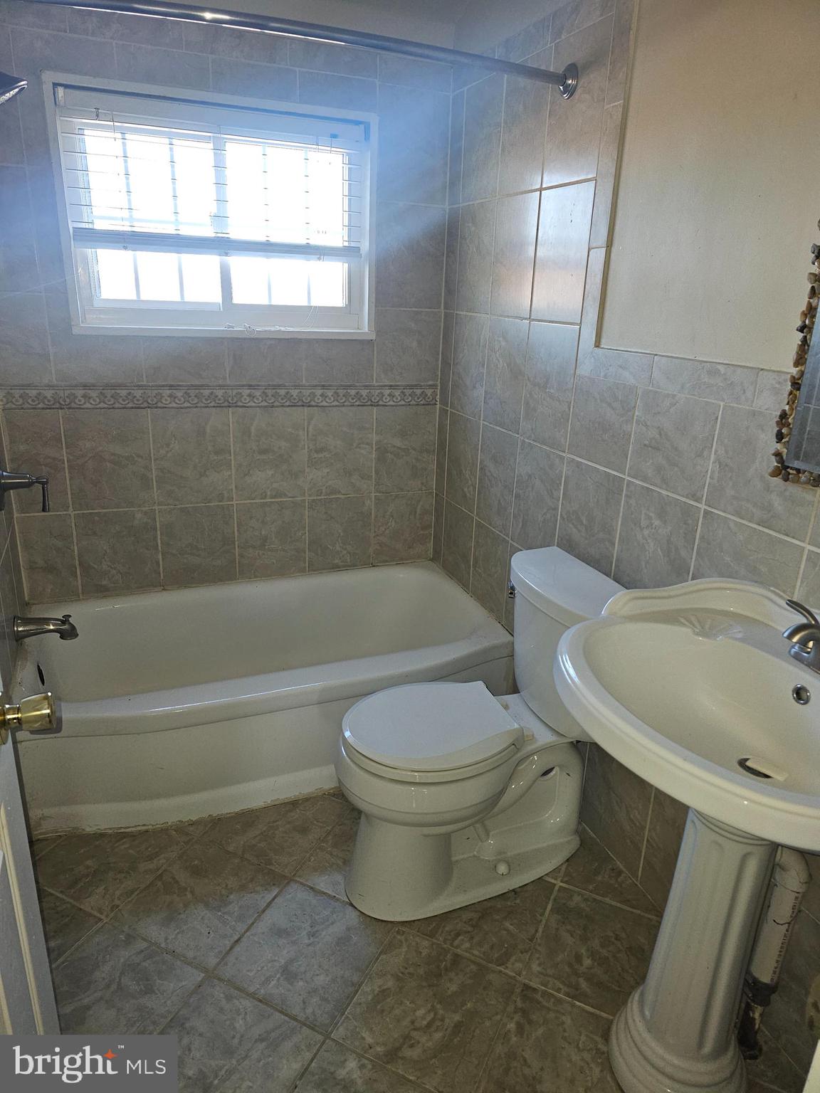 4728 Williston Street Baltimore, MD 21229 - Photo 8 of 17 a bathroom with a toilet and a bathtub