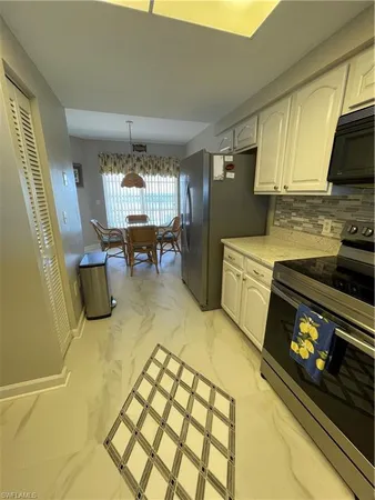 a kitchen with a sink and a stove top oven