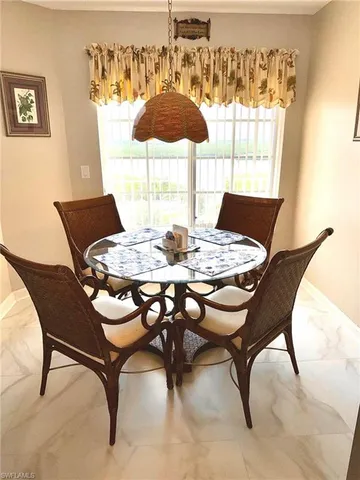 a dining room with furniture and window