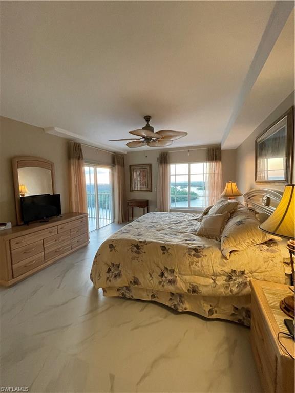 13105 Vanderbilt Drive, Unit 808 Naples, FL 34110 - Photo 15 of 26 a spacious bedroom with a bed and a flat screen tv