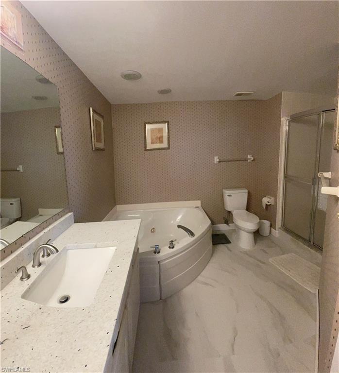 13105 Vanderbilt Drive, Unit 808 Naples, FL 34110 - Photo 16 of 26 a spacious bathroom with a tub sink and a toilet