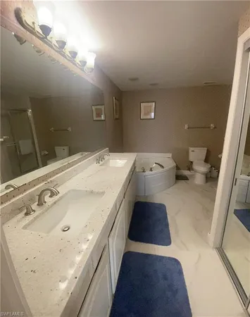 a spacious bathroom with a tub sink and vanity