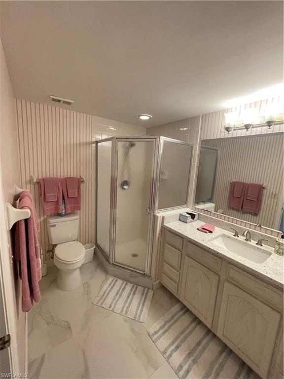 13105 Vanderbilt Drive, Unit 808 Naples, FL 34110 - Photo 20 of 26 a bathroom with a sink a toilet and shower