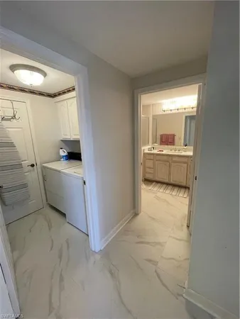 a kitchen with a sink and white cabinets
