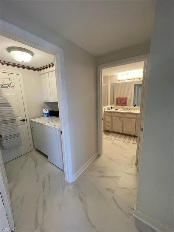 13105 Vanderbilt Drive, Unit 808 Naples, FL 34110 - Photo 21 of 26 a kitchen with a sink and white cabinets