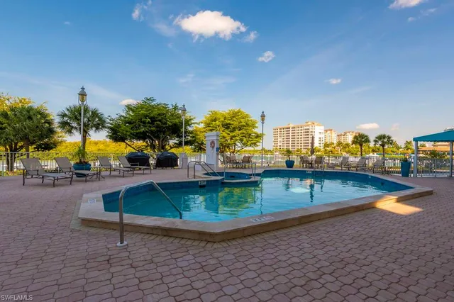 a view of a swimming pool with an outdoor seating and a yard