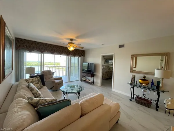 a living room with furniture and a large window