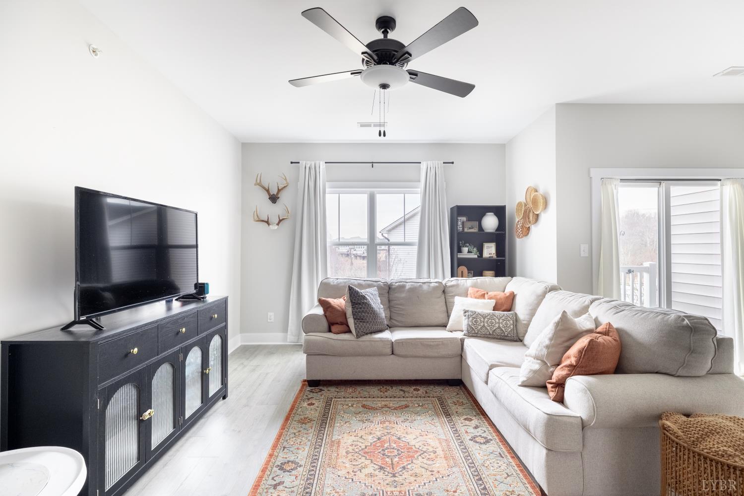 1301 Stoney Ridge Boulevard, Unit 208 Forest, VA 24551 - Photo 15 of 46 a living room with furniture and a flat screen tv