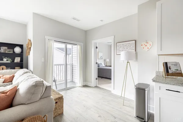 a living room with furniture a refrigerator and a sink