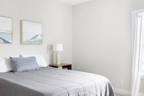 a bedroom with a bed and a window