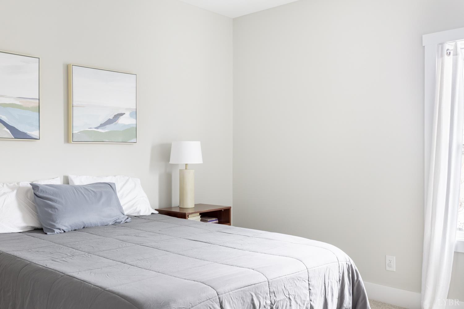 1301 Stoney Ridge Boulevard, Unit 208 Forest, VA 24551 - Photo 24 of 46 a bedroom with a bed and a window