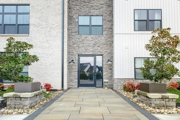 a view of a brick house with potted plants