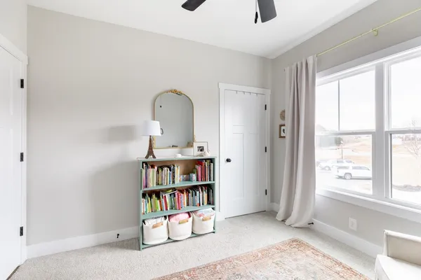 a view of room with toys and a book shelf