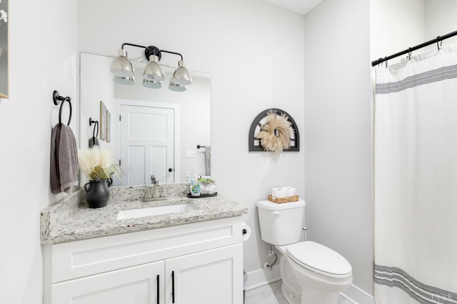 1301 Stoney Ridge Boulevard, Unit 208 Forest, VA 24551 - Photo 35 of 46 a bathroom with a granite countertop toilet sink and mirror