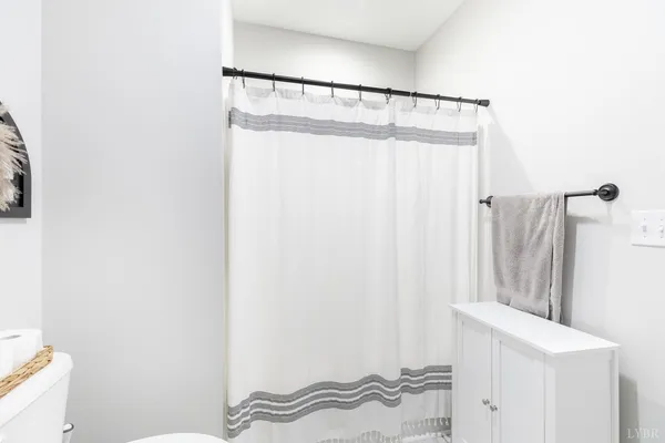 a bathroom with a shower curtain and a sink
