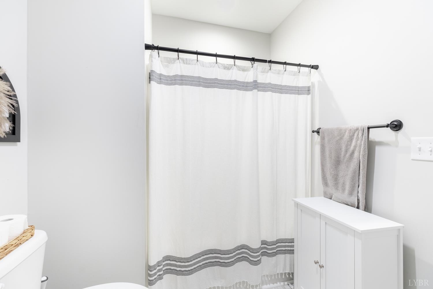 1301 Stoney Ridge Boulevard, Unit 208 Forest, VA 24551 - Photo 36 of 46 a bathroom with a shower curtain and a sink