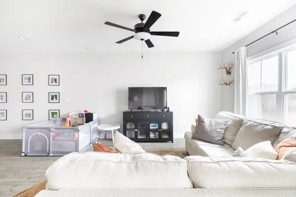 a living room with furniture a refrigerator and a sink
