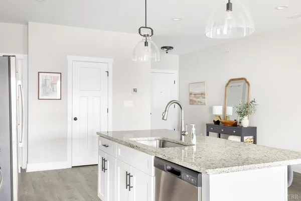 a kitchen with sink and chandelier