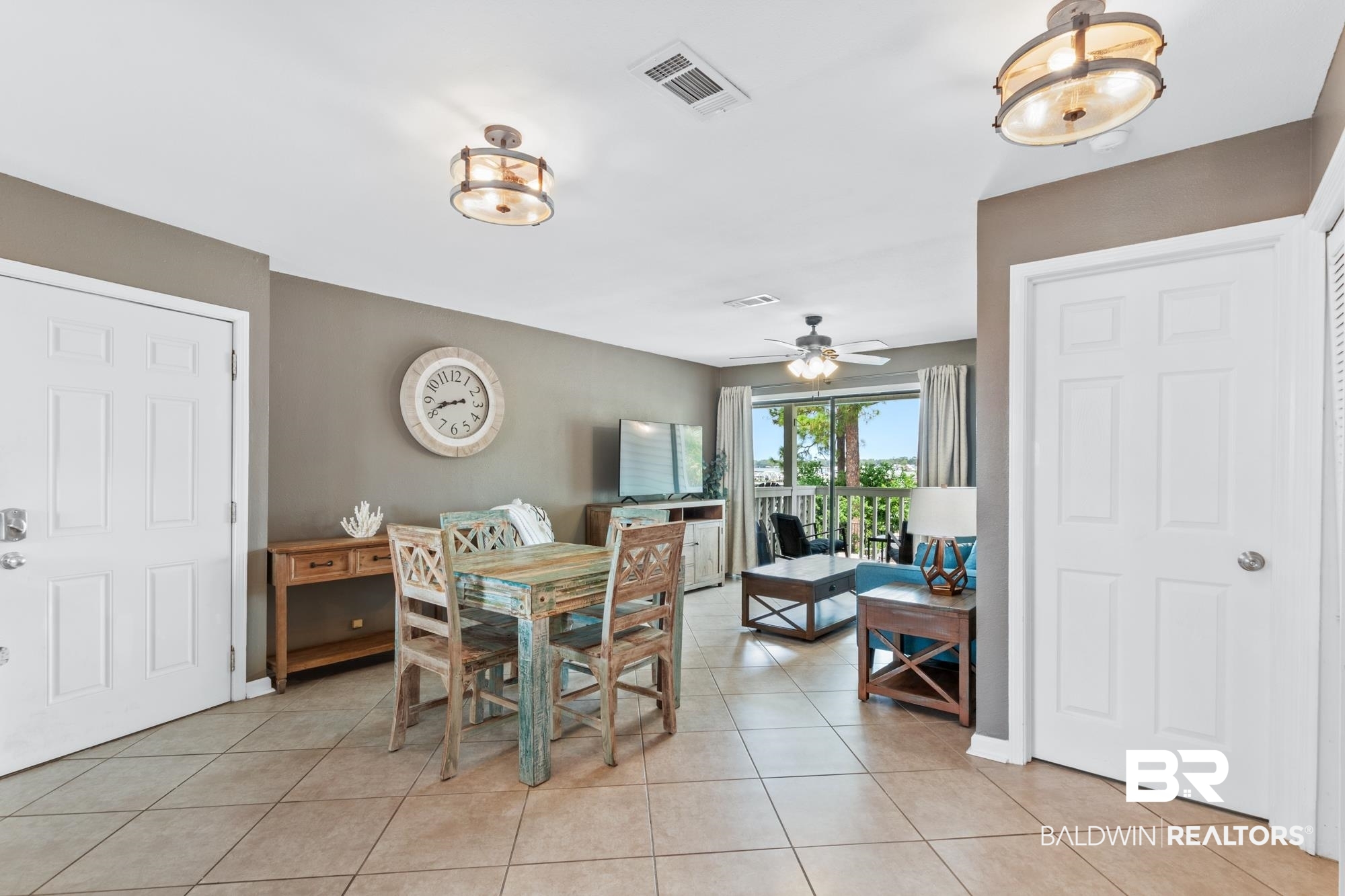 25925 -C Canal Road, Unit 203 Orange Beach, AL 36561 - Photo 3 of 57 Dining space featuring light tile patterned floors and ceiling fan