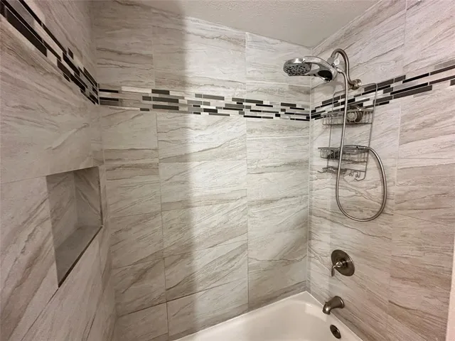 en empty room with windows and ceiling fan