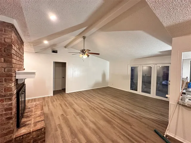 a view of a hallway with wooden floor and a sink