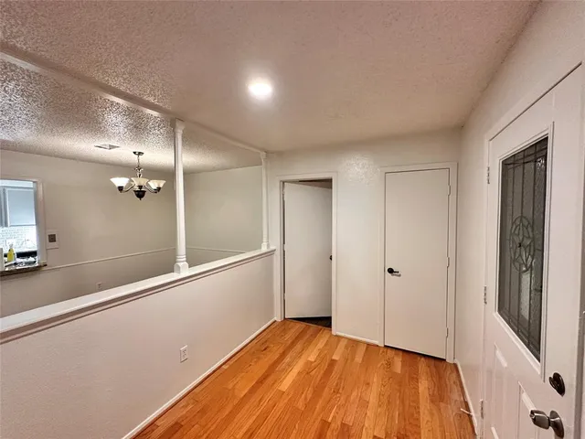 a view of a room with wooden floor