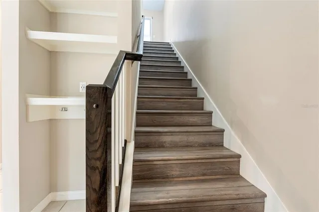 a view of entryway and hall with wooden floor