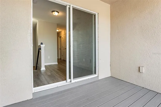 an empty room and wooden floor with a bathroom