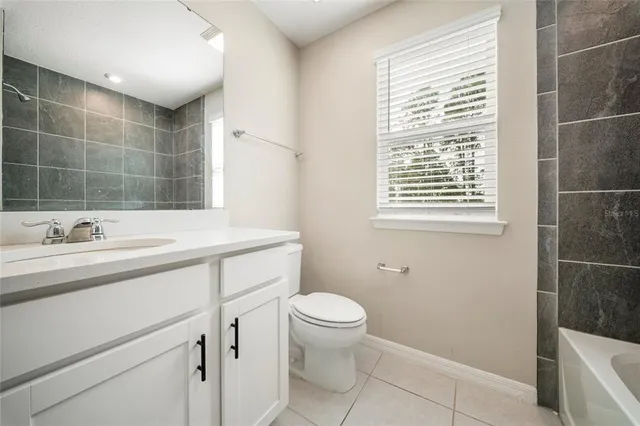 a bathroom with a sink a toilet and a shower