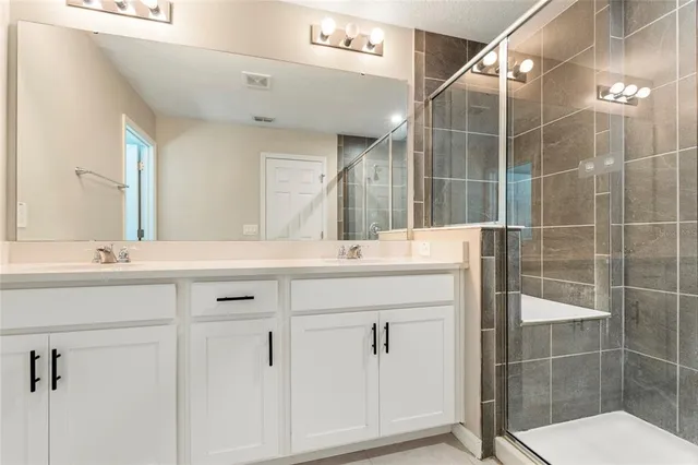 a bathroom with a sink mirror and double